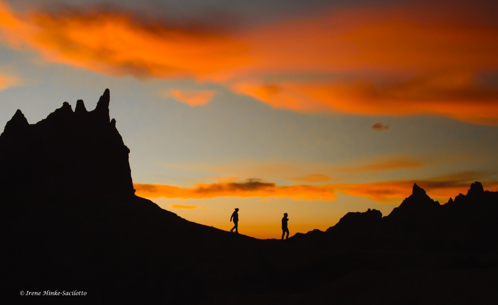 Hikers in the Badlands at sunset